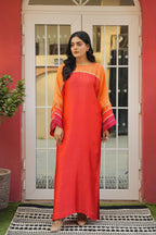 Woman wearing a fiery red & sunset orange outfit with gold accents