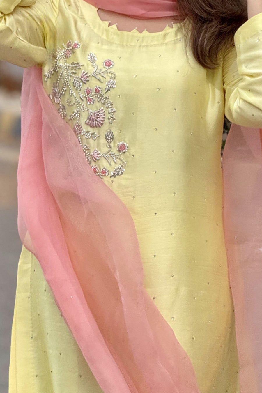 Yellow outfit with pink dupatta and floral embroidery