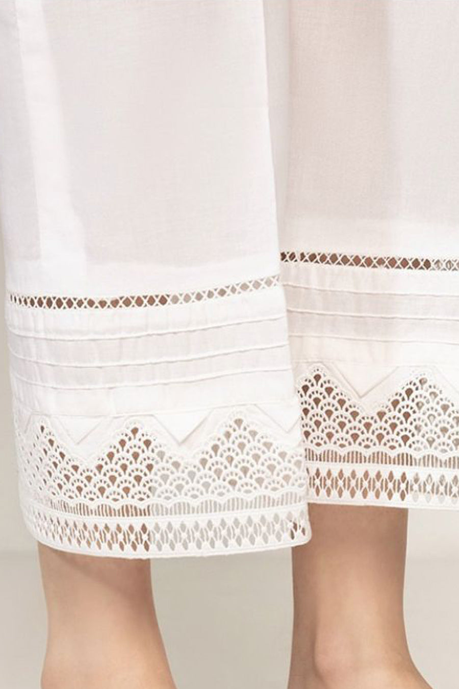 White lace-trimmed dress on a plain background