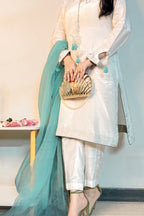 Person wearing a traditional outfit with a teal dupatta and gold clutch.