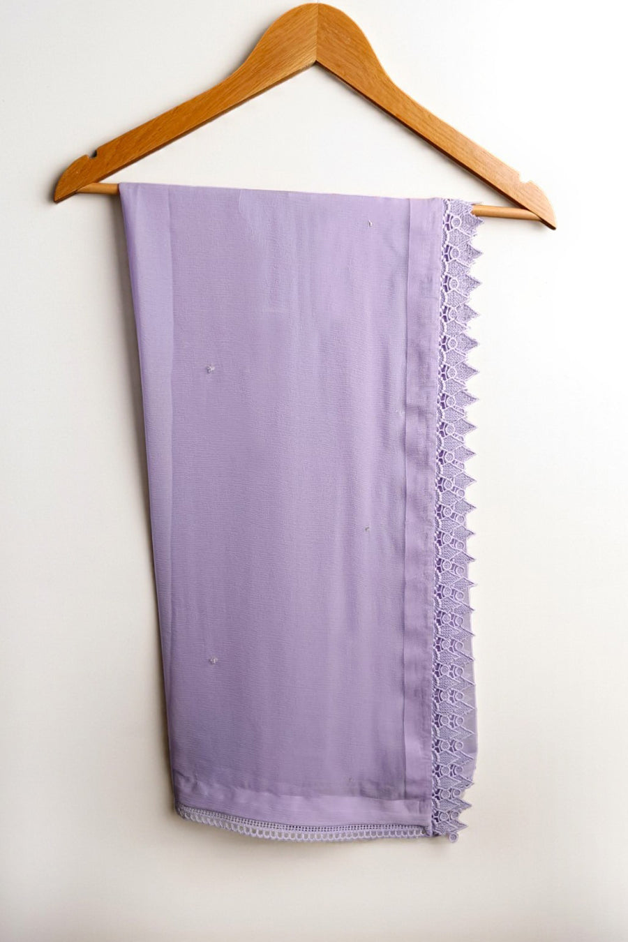 Lavender scarf with ruffled edge on a wooden hanger against a white background